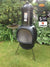 Gardeco Asteria Extra Large Black Chimalin AFC Chiminea In A Garden Setting | SKU: AFC-C51.75 | Barcode: 5031599045290