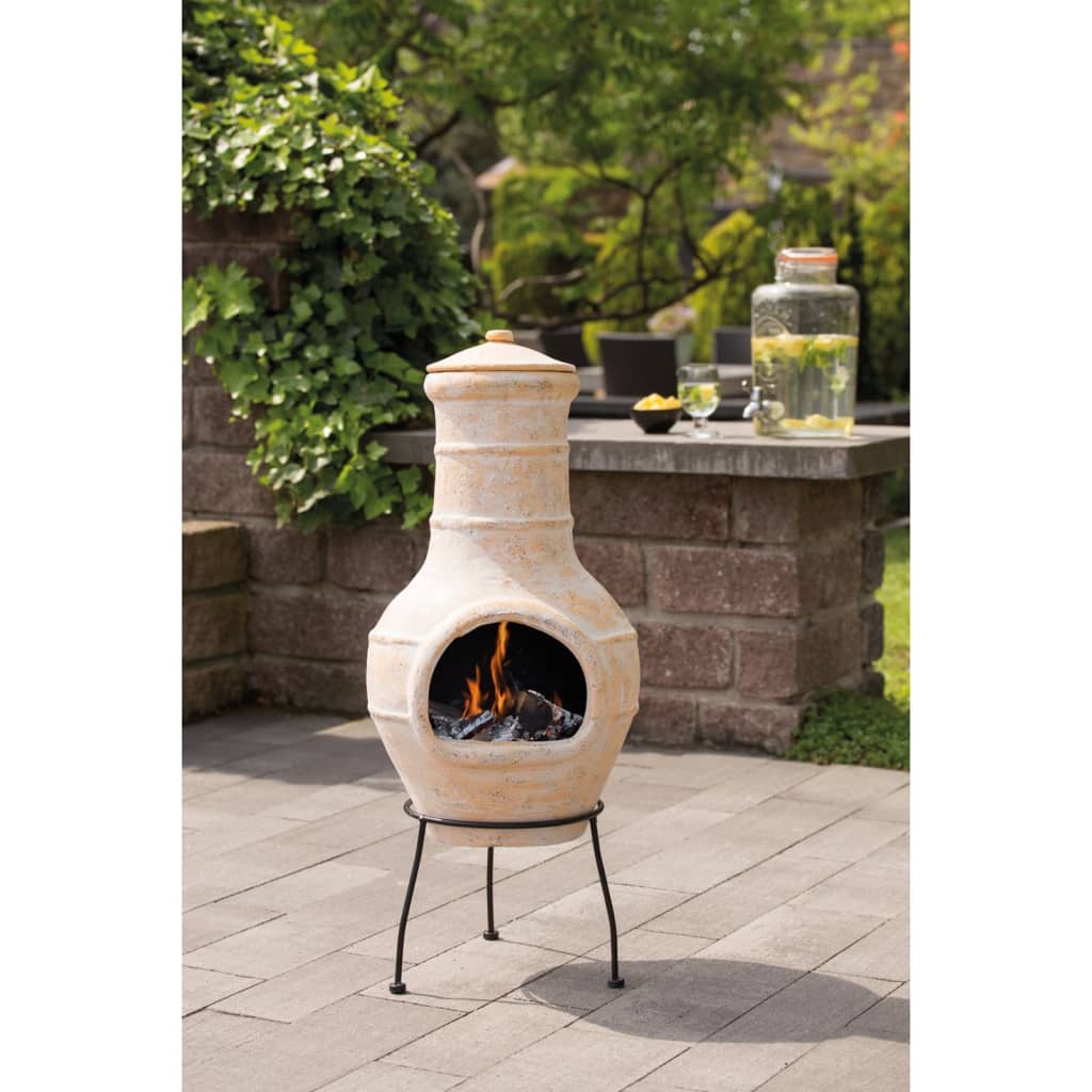 RedFire Star Flower Clay Chiminea / Outdoor Fireplace In Straw Colour With Burning Logs Inside In A Garden Setting | SKU: 411837 | Barcode: 8718801854754